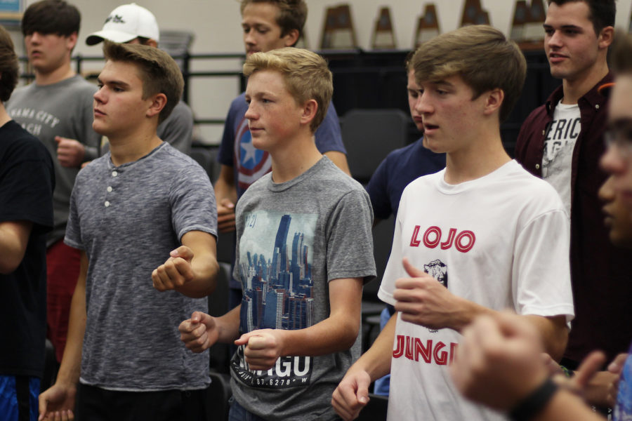 Seniors Chris Drye, Reed Fraser, and junior Weston Ludlow practice their selected song for the OSU trip.