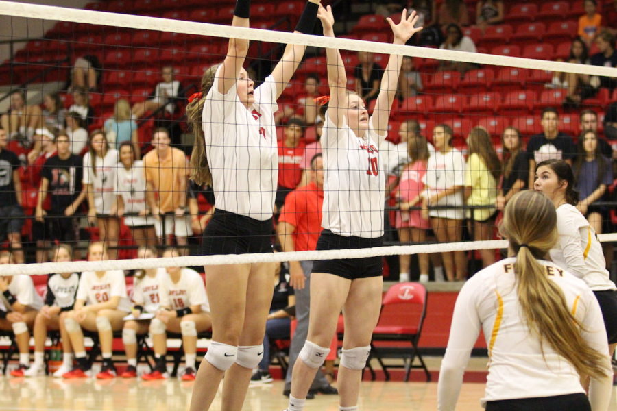 Junior Racheal Langs and sophomore Madison Watters protect the net for their team.