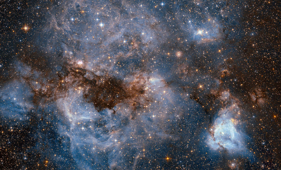 This shot from the NASA/ESA Hubble Space Telescope shows a maelstrom of glowing gas and dark dust within one of the Milky Way’s satellite galaxies.