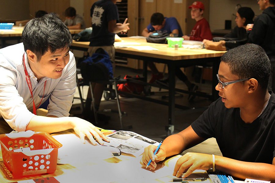 New art teacher Brian Cho helps Art I student Tyrese LaMaison on his drawing. Cho has lived in multiple states and two countries before making his way to Texas.