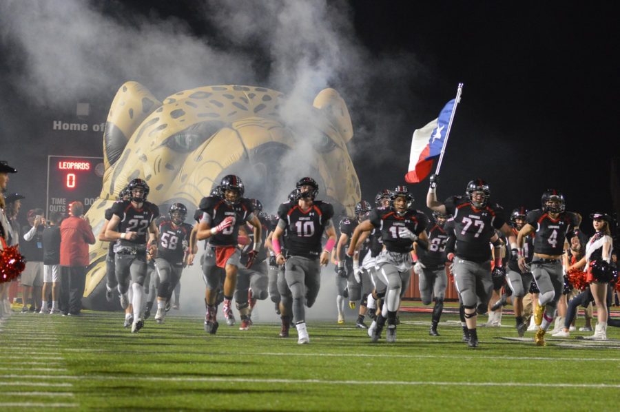 The football team race s out of the Leopards mouth in front of the FNL crowd.