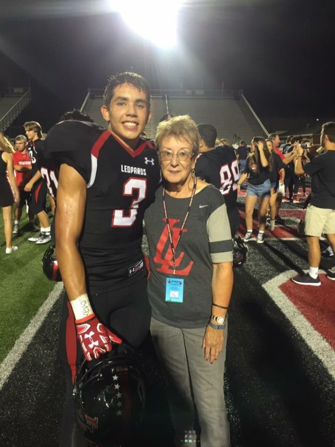 After a home win against Frisco Wakeland, Jane takes a photo with senior safety Blake Pfaff.