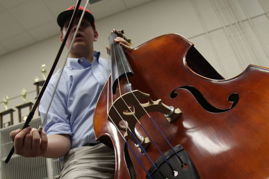 Freshman Justin Maroney holds his instrument 