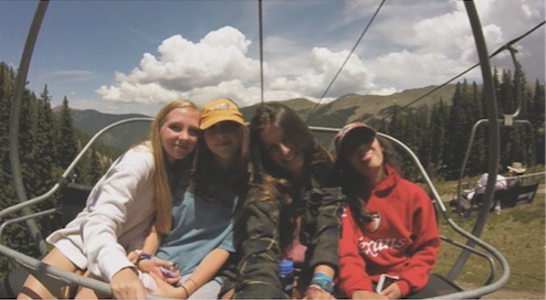 Freshman cross country members take a break on a ski lift in Taos while on their way to the top of the mountain. Once at the top, the team went on a hike.