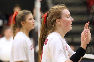 Senior Haley Deschenes is awaiting the opposing teams serve to her side of the court.