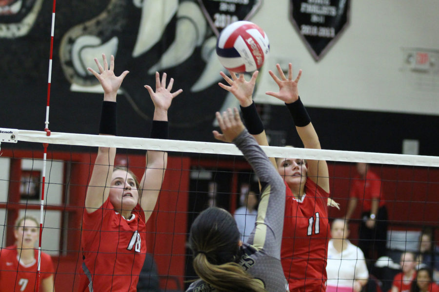 Seniors Paige Becker and Bailey Downing block Royse City's hit.