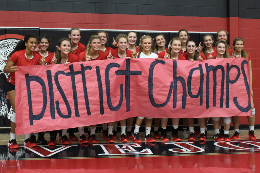 The volleyball team celebrates their district championship after a win over Royse City.