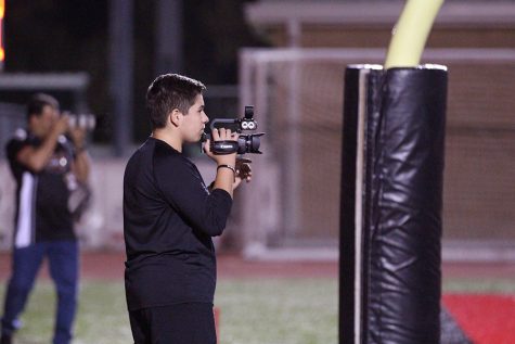 Ray gets to be on the field at games as press to shoot his videos.