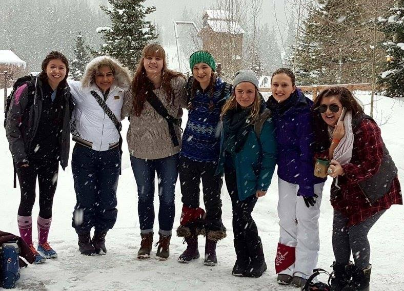 Ellie Hager, Jillian Sanders, Katy Park, and Allen Younglife students pose at the basin of the Winter Park Ski Resort on last years ski trip. 