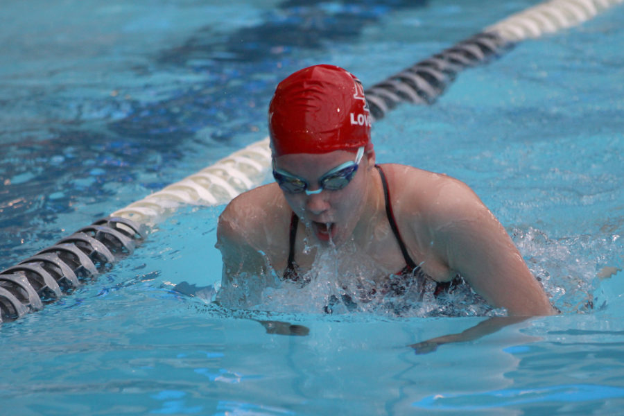 Freshman Jackie Carroll races in the breaststroke race.