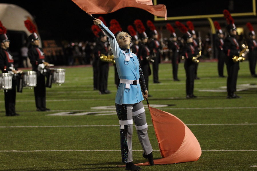 Even though football season is over, the color guards, including Madeleine Hamilton, are continuing to preform. 