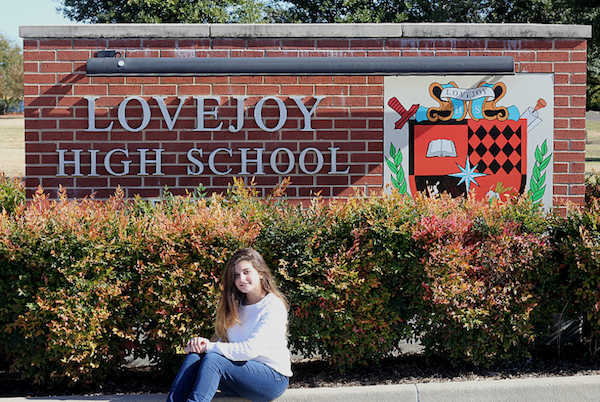 Hannah DIorio sits in front of the LHS school sign