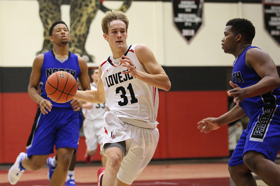 Senior Braden Ledebur dribbles down court avoiding defenders against North Forney on Saturday.