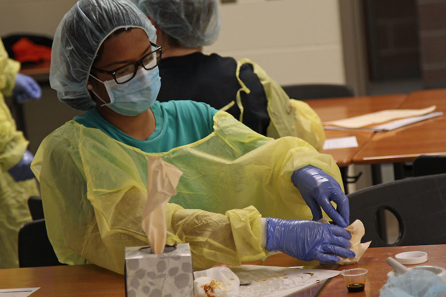 Senior Shivani Kalavala seals the container of paste solution.