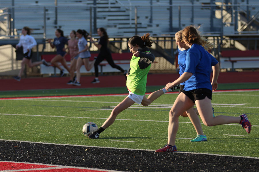 Sophomore Cassidy Lichenburg  and members of the varsity girls soccer team scrimmage after winter break.