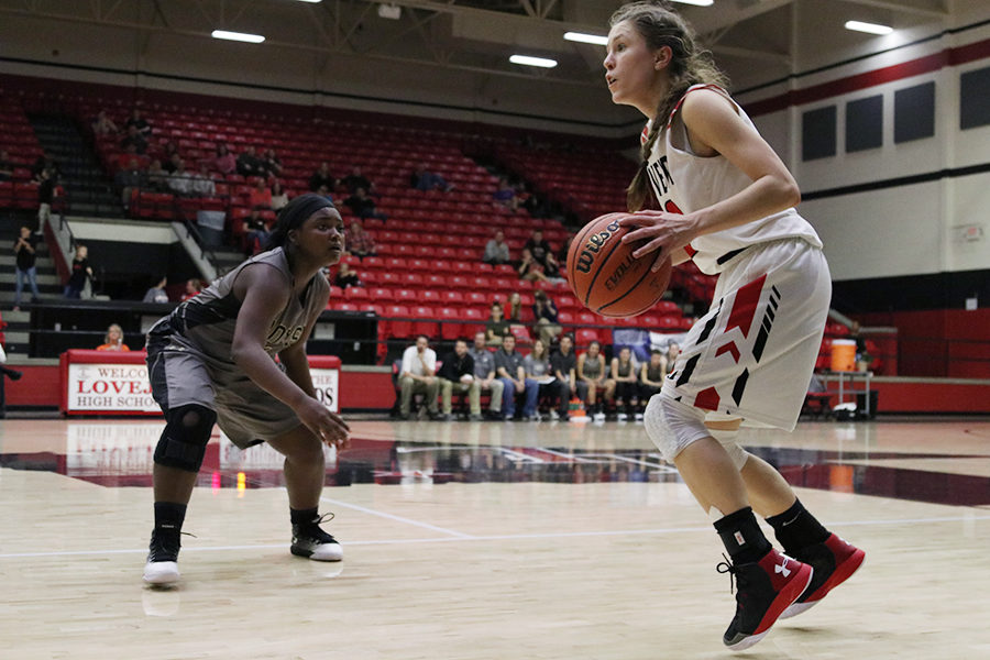 Junior Meredith Elhman holds the ball up waiting for the play to develop.