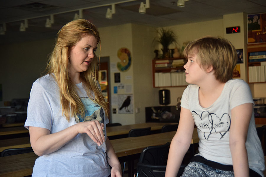 Art teacher Amanda Beller talks with her daughter, Lane, during eighth period. Amanda and her husband, Justin, said they have been intentional about providing their children first-hand experiences with social justice issues.