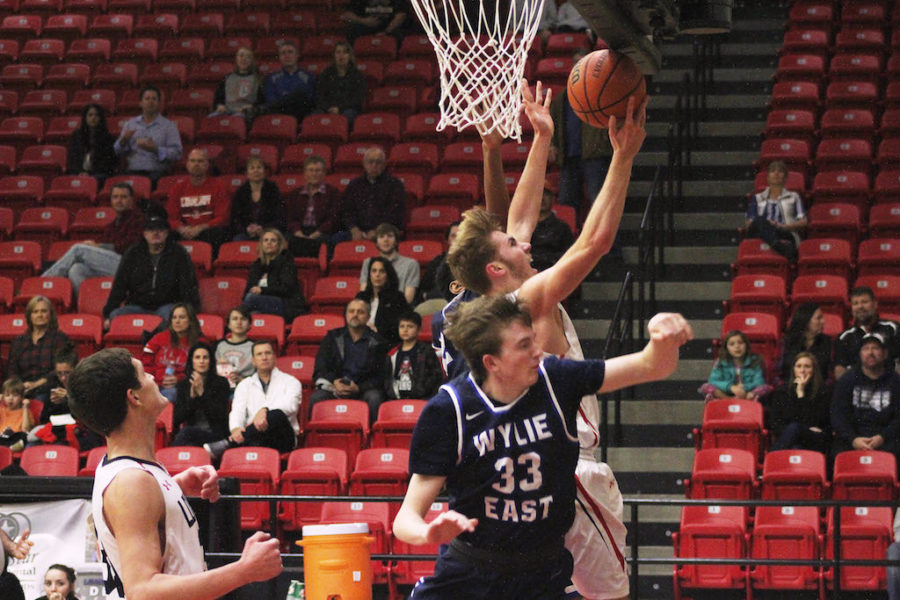 Sophomore Kyle Olson jumps for a lay up while fighting off two Wylie East Defenders.