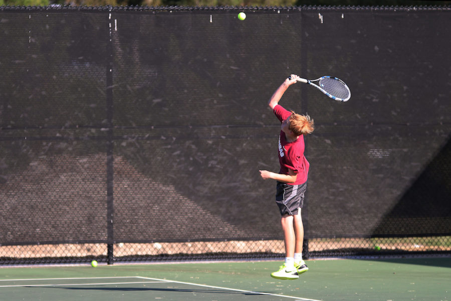 Sophomore Caiden Tays jumps to hit ball across the court.