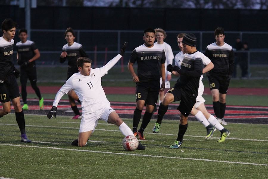 Senior Cal Cranfill stops the ball in front of the Royse City defenders.