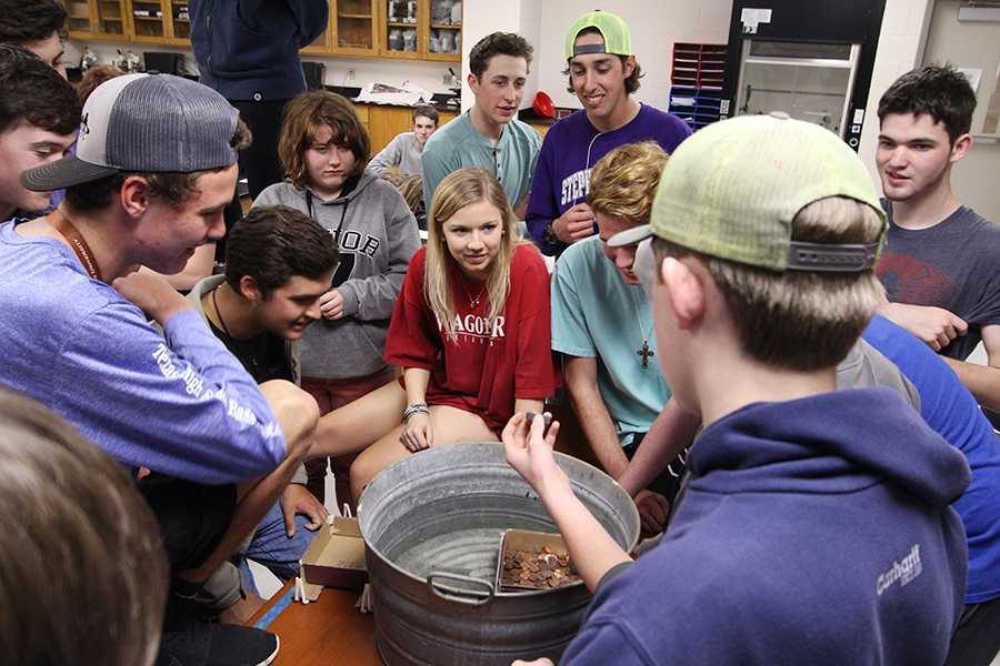 The Outdoor Adventures class tests their boat designs by counting the amount of pennies the boats could carry.