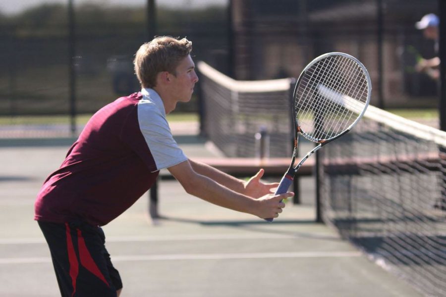 Sophomore Dylan Smith prepares for the serve.