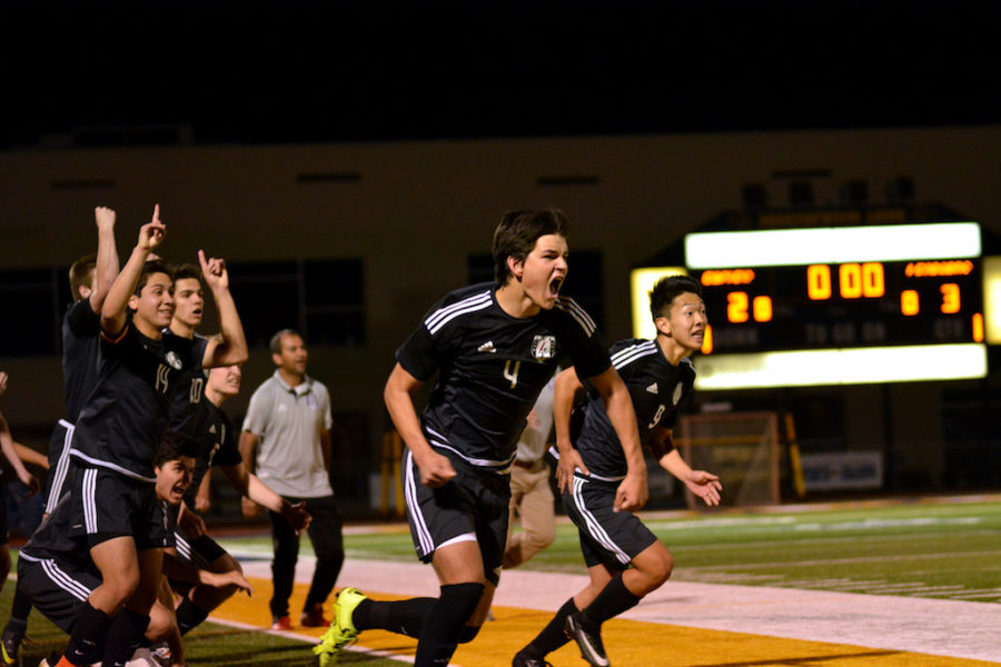 Junior Grant Lange and Sophomore Christian Kwon race to celebrate after beating Prosper in a penalty shootout.