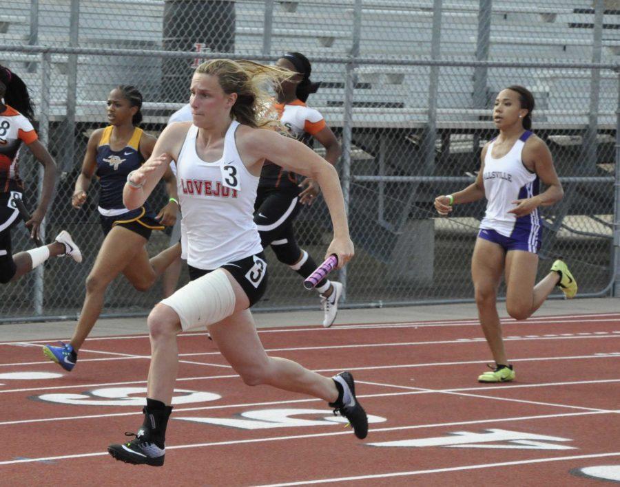 Junior Grace Ridgeway sprints ahead of her competitors in the 4x100 relay. The 4x100 girls team advanced to regionals.