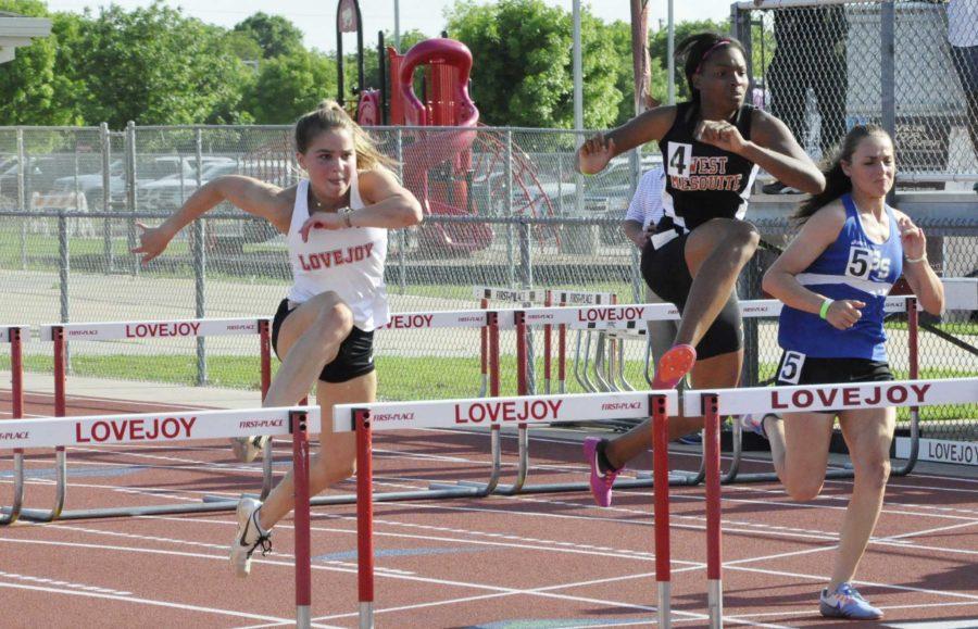 Junior Juliet Franz clears the second hurdle during the 100m hurdles. Franz went on to place second in the event and qualify for regionals. 