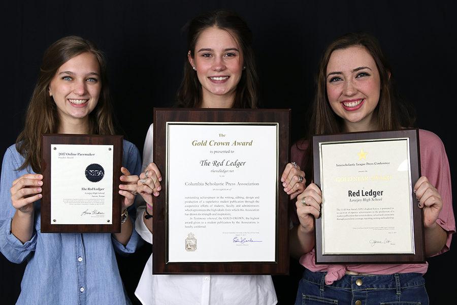 Seniors and editors-in-chief Jillian Sanders, Hallie Fischer, and Caroline Smith hold up the NSPA Pacemaker Finalist, CSPA Gold Crown, ILPC Gold Star awards.