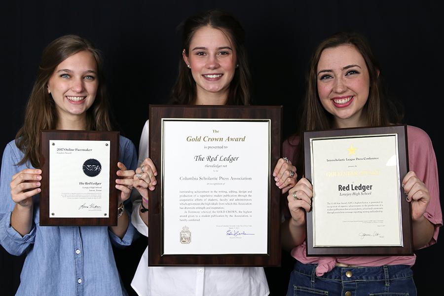 Seniors and editors-in-chief Jillian Sanders, Hallie Fischer, and Caroline Smith hold up the NSPA Pacemaker Finalist, CSPA Gold Crown, ILPC Gold Star awards.
