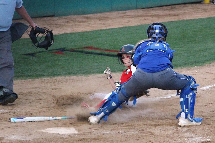 Senior Alex Bellows sliding home during 3rd inning.