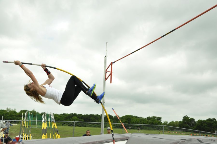 Junior Grace Ridgeway jumps 12-02.00 to place first in pole vault and tie the school record. 