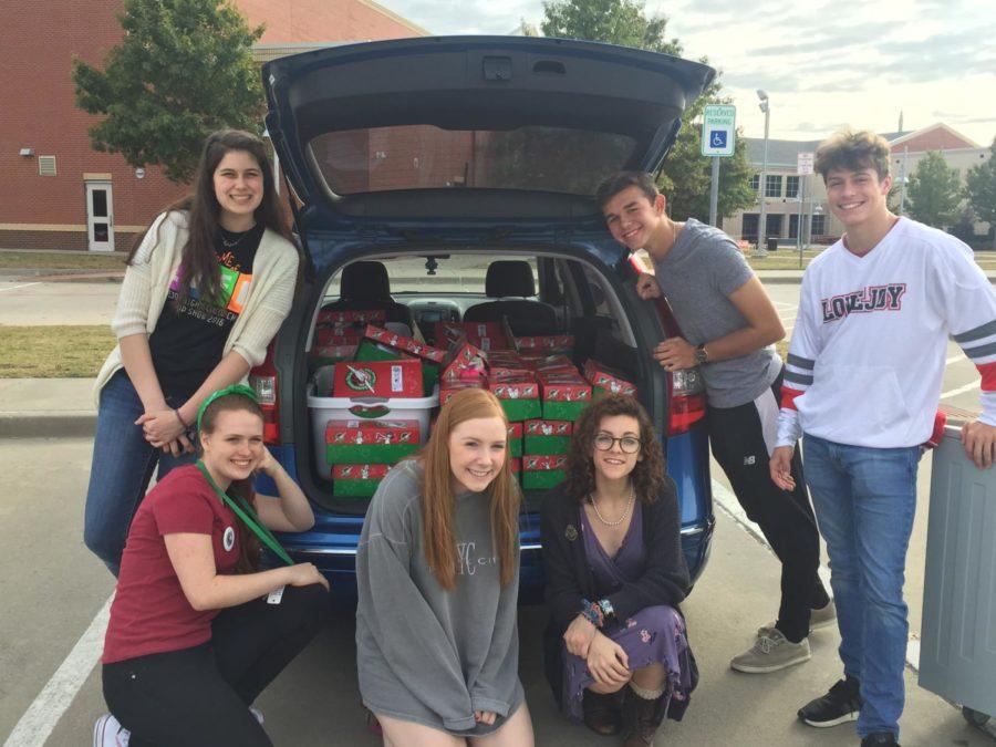 Senior Mandy Rickett, second to the left, and friends who helped pack the boxes packed the gifts in the car to bring them to Operation Christmas Child headquarters. From there they will be given to children in need of christmas gifts.
