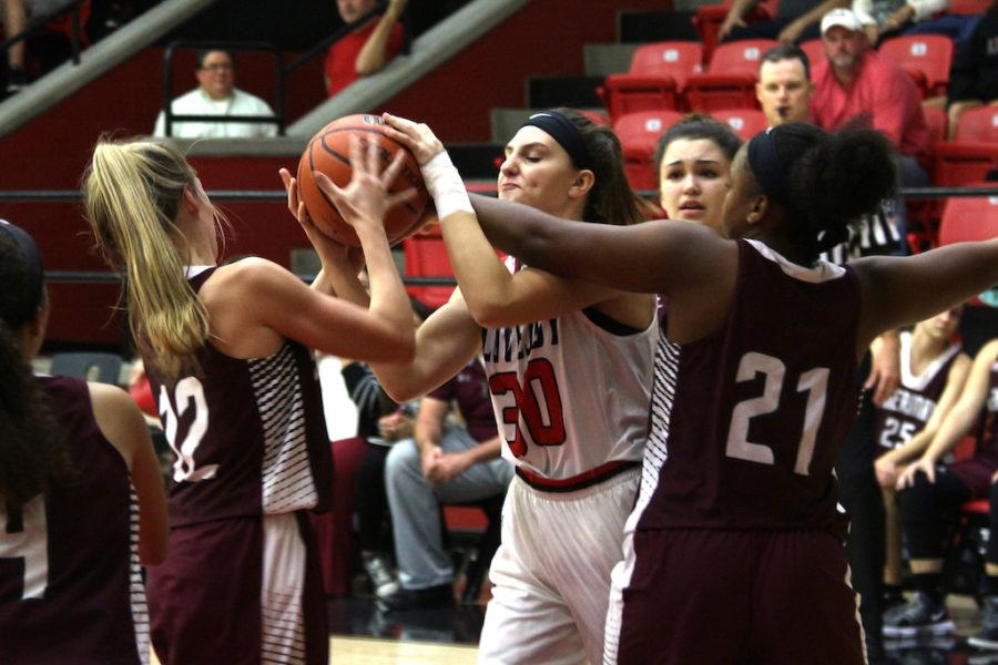 Junior Alexandra Brungardt is fouled as she pulls up her arms to shoot.