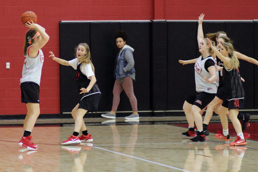 Junior Carson McFadden guards a teammate while trying to pass to senior Ireland Miller.