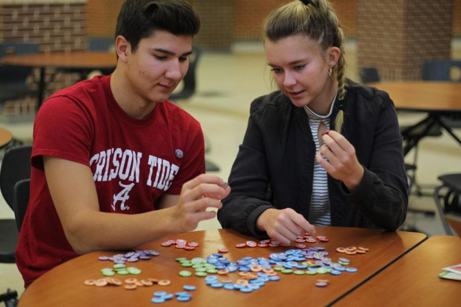 Seniors Turner Thompson and Parker Johnson sort buttons in preparation for Dude, Be Nice week.