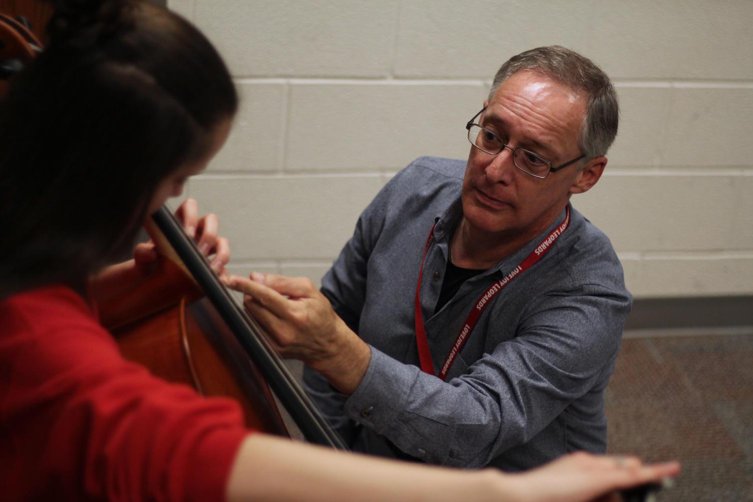 Cello instructor Phillip Taggart teaches students in the school. Students have said they learn life lessons from him, and he is their good friend.