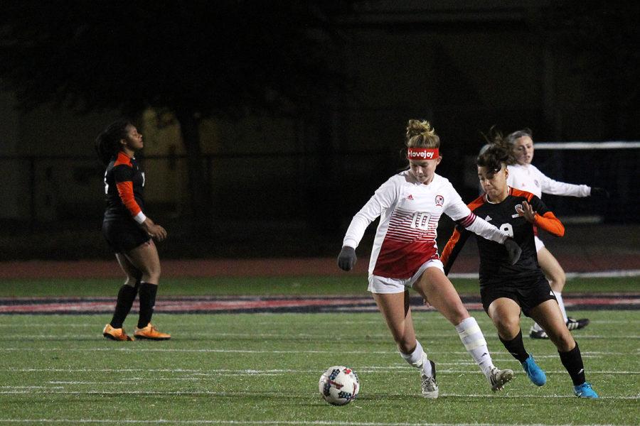 Senior soccer player Turner Thompson dribbles past a West Mesquite defender.