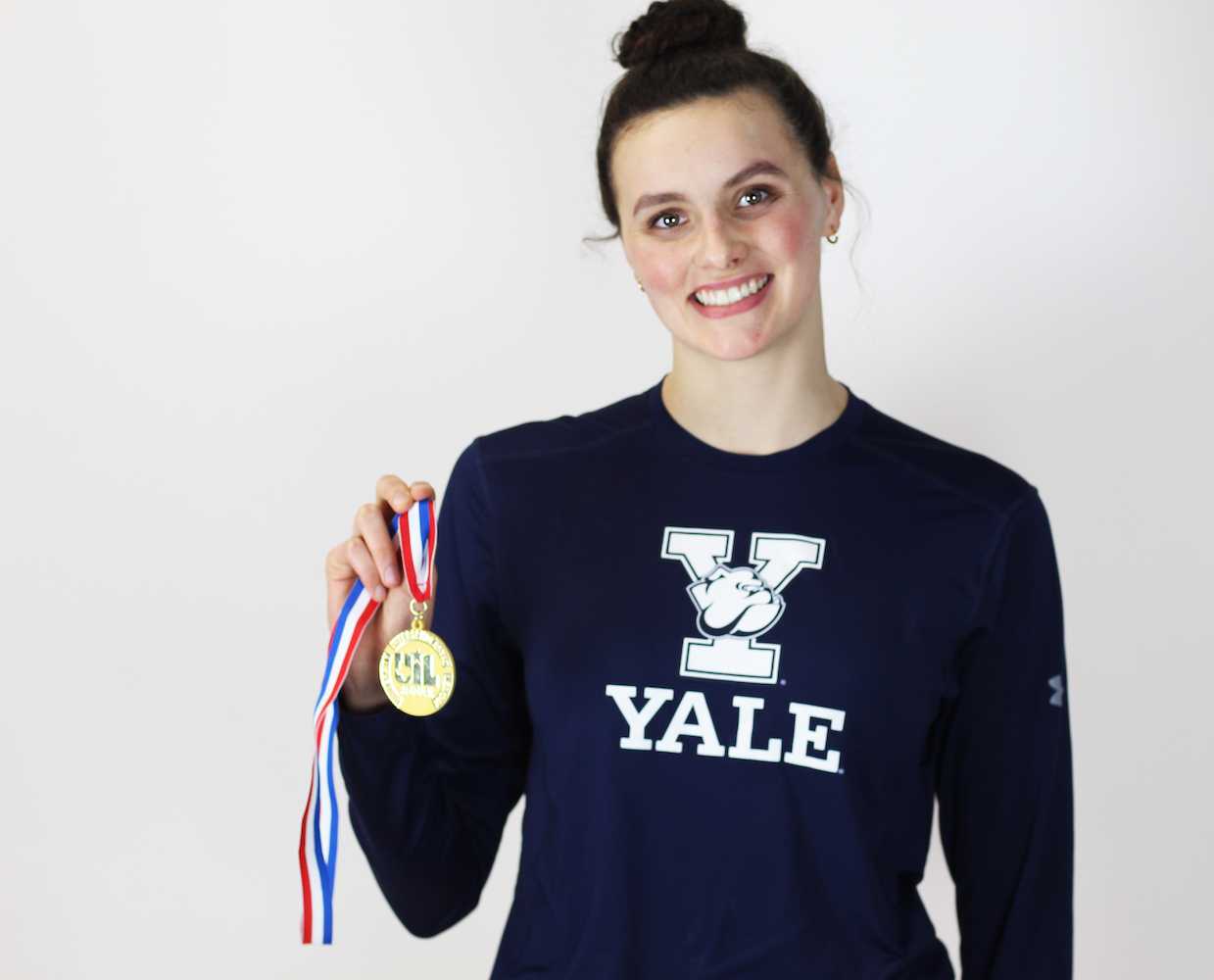 Senior Raime Jones, a future Yale student and swim team member, poses with her medal for winning the 500 meter freestyle at the 5A state meet.