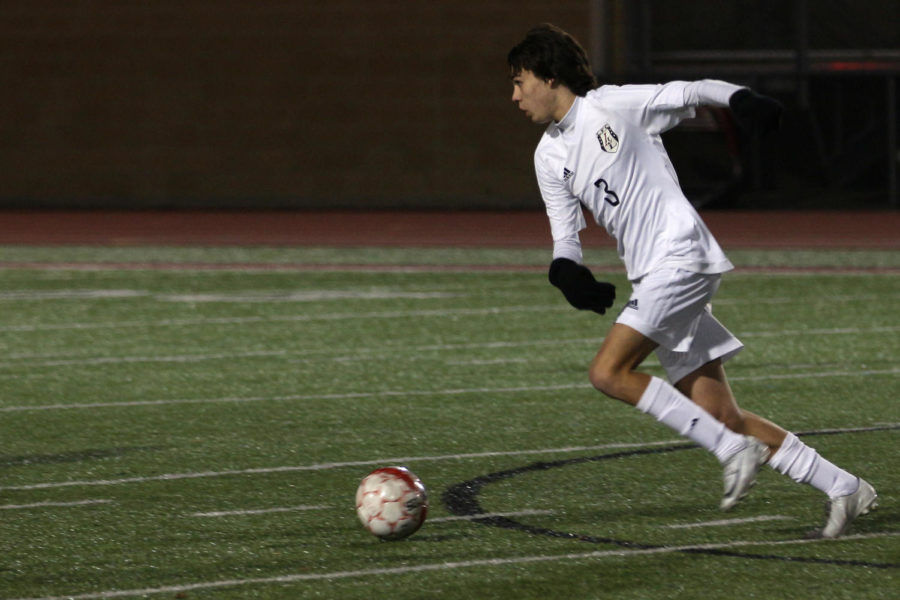 Junior Caleb Toomey races up the field with the ball against Forney.