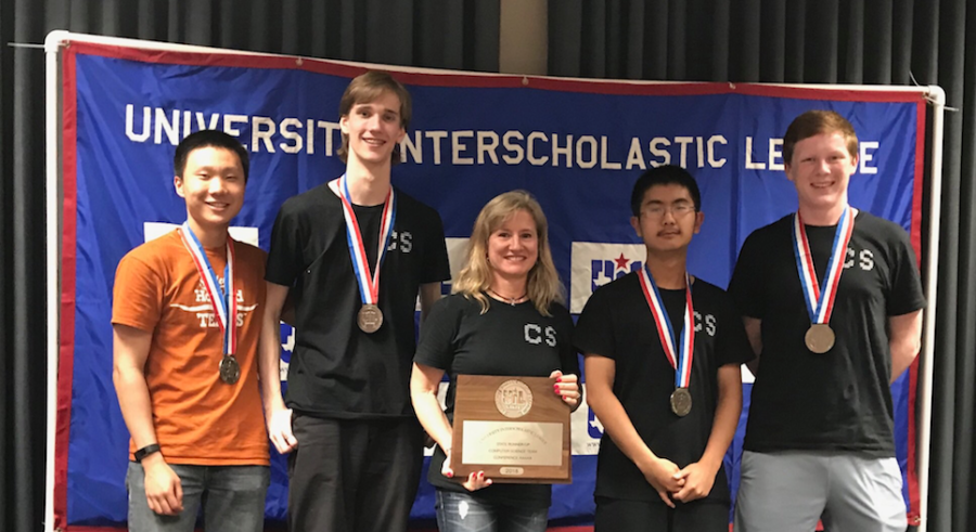 The computer science team poses on the podium with their second place trophy. 