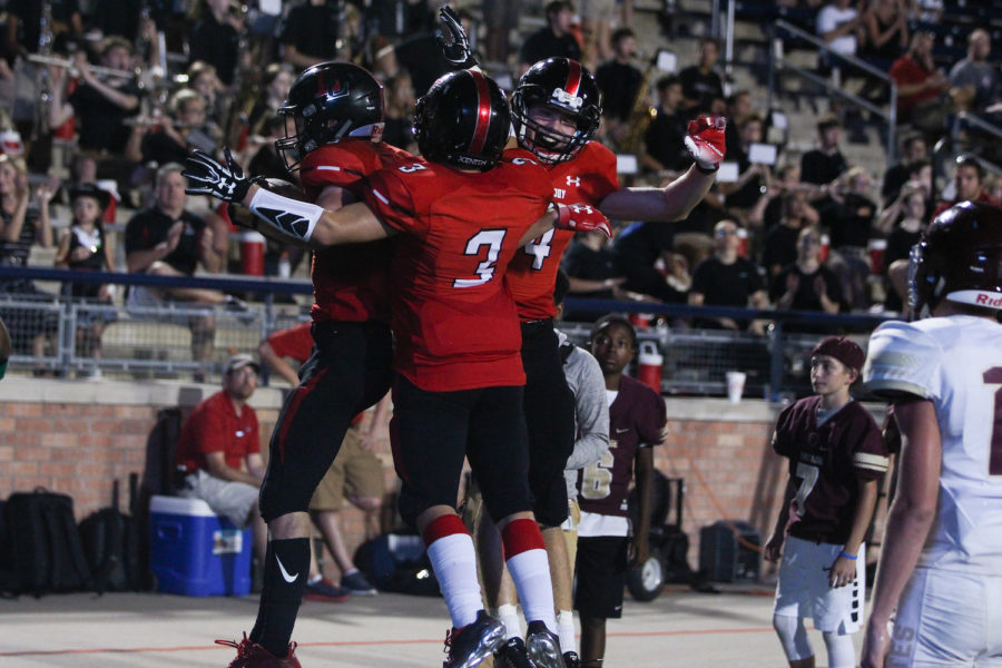 The Leopards offense celebrates one of its six touchdowns in a 42-26 victory over Frisco Heritage.