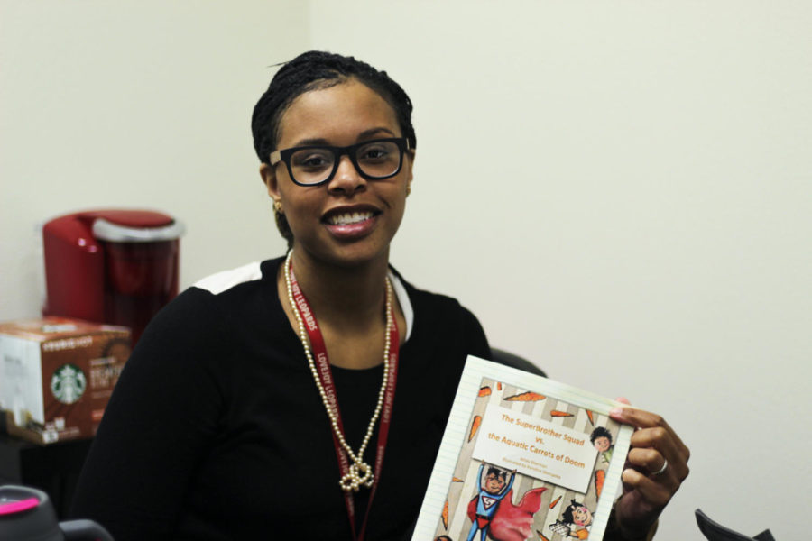 Leadership teacher Jenay Sherman poses with her self-published childrens book. 