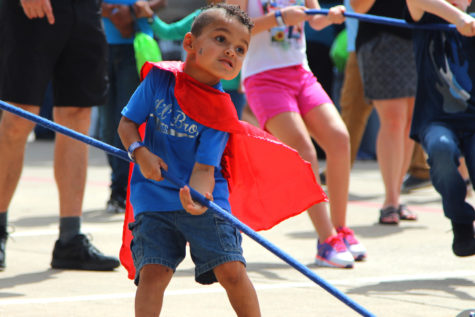 A child participates in Ford Experience- Raise the Wall tug-of-war game in efforts to win a free hat.