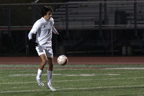 Senior Caleb Toomey passes the ball to a teammate.