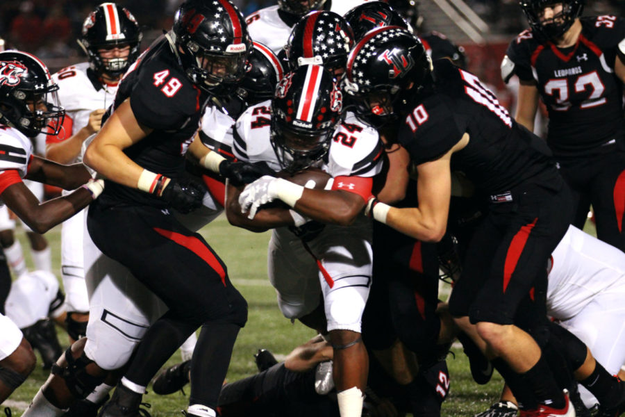 Senior Nathaniel Finch (left) and sophomore Ralph Rucker (right) attempt to stop Braswell running back Kaivon Kendrick.