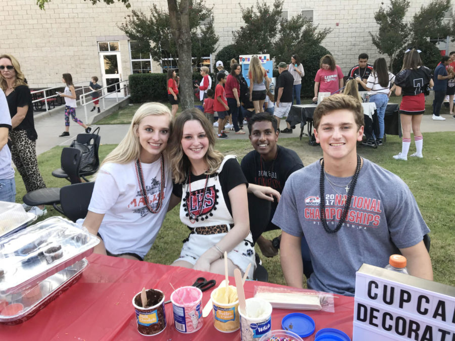 (Left to right) Jaden Lewis, Emma Davis, Peter Godipelly, and Jordan Yoder run the baking club booth at Leopard Friday.