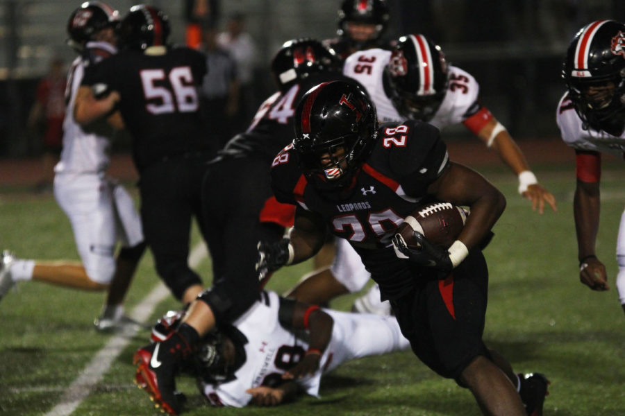 Senior running back Jahi Rainey looks to turn up field to reach the first down marker.