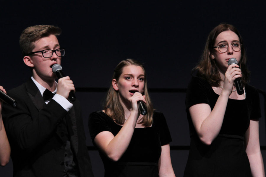 Senior Marcie Sawyers (center) sings with juniors Stephen Godfrey (left) and Claire McLaren (right) during a concert. 